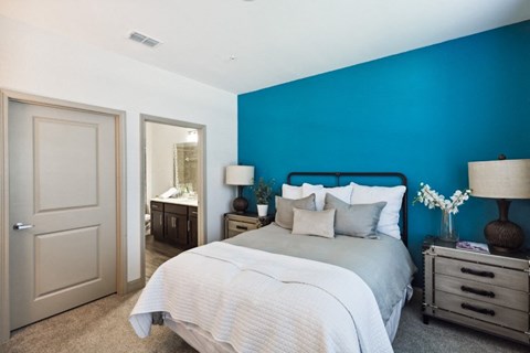 Bedroom with Blue Wall and a Mirror at The Loree, Jacksonville, FL, 32256