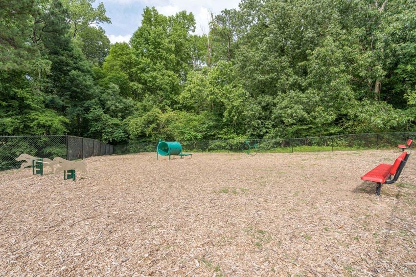 a large fenced in area with a picnic table and a red bench - Photo Gallery