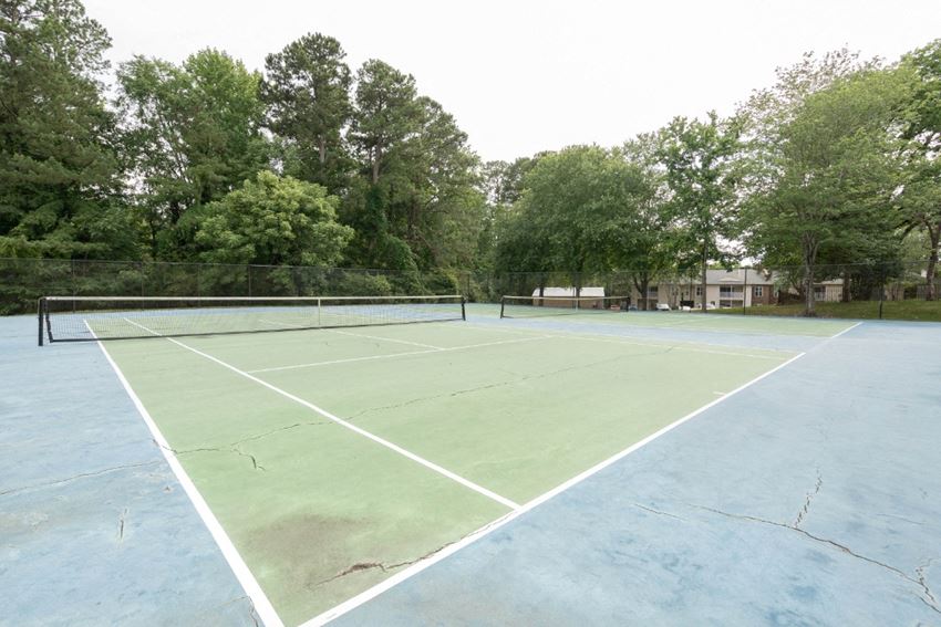 a tennis court at the whispering winds apartments in pearland, tx - Photo Gallery