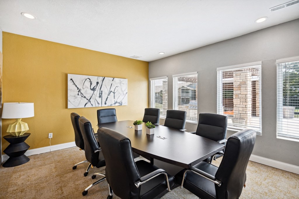 a conference room with a large table and chairs at The Reserve At Barry Apartments, Kansas City, Missouri
