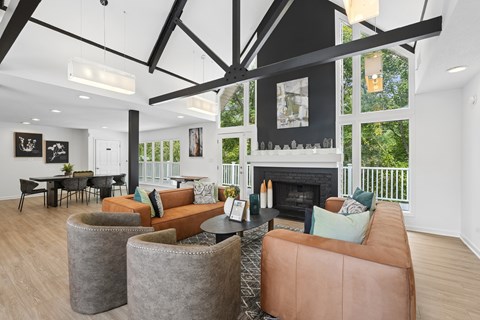 Community clubhouse lounge with fireplace and balcony access at Park Ridge Estates