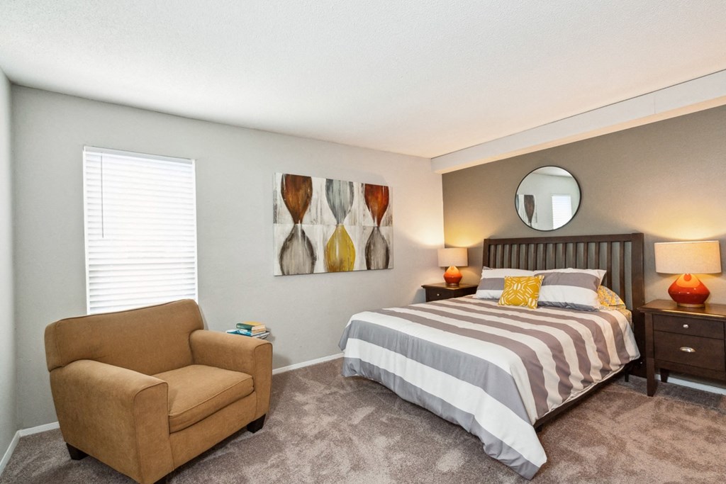 a bedroom with a bed and a chair