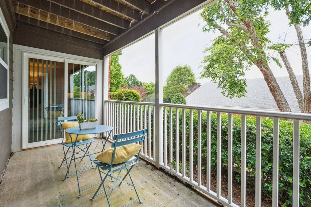 a patio with a table and chairs and a sliding glass door