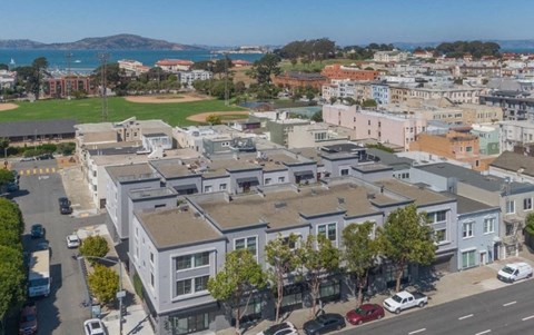 A view of a residential area with houses and cars.