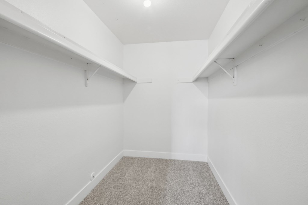 A room with white walls and a carpeted floor at Candela Park Apartments, Mesa 85201