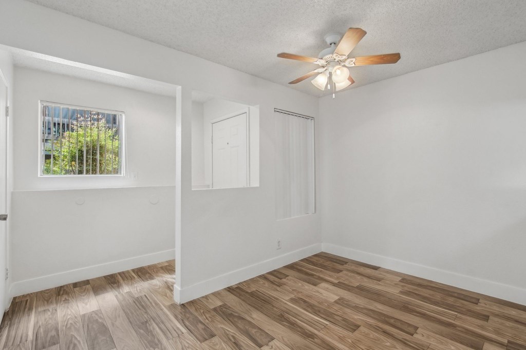 A room with a ceiling fan and wooden flooring. at Candela Park Apartments, Mesa, AZ, 85201
