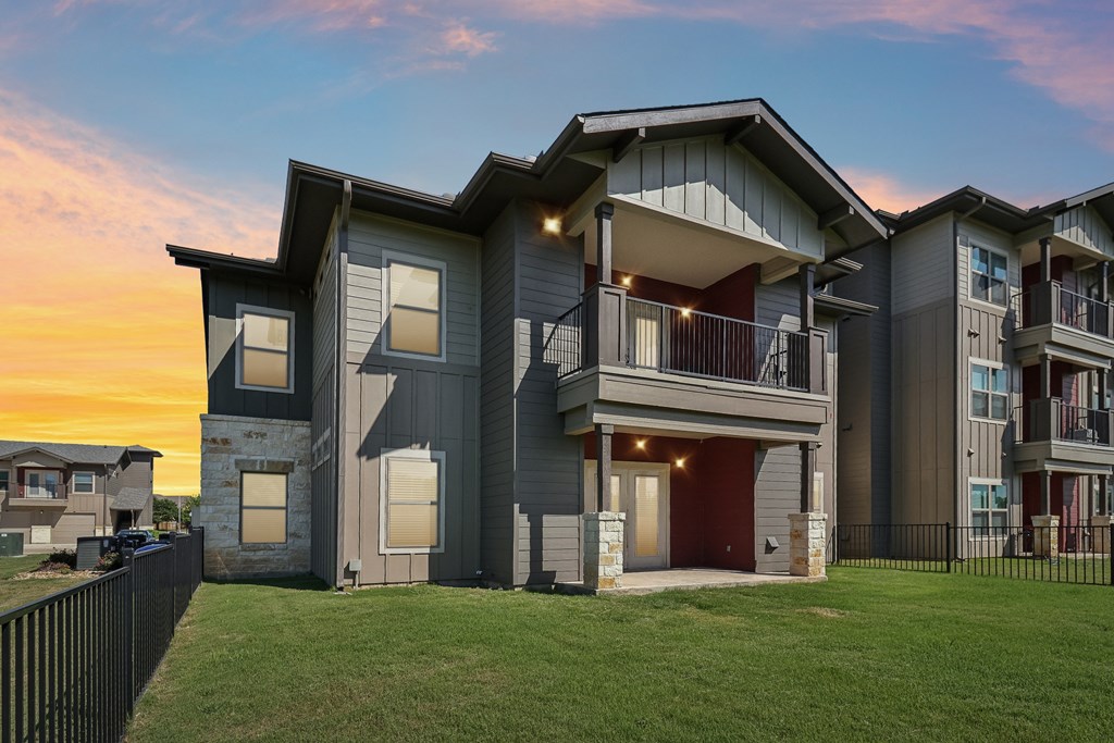 A modern two-story house with a balcony and a garage.