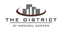 The image is a logo for at District at Medical Center, San Antonio, 78229
