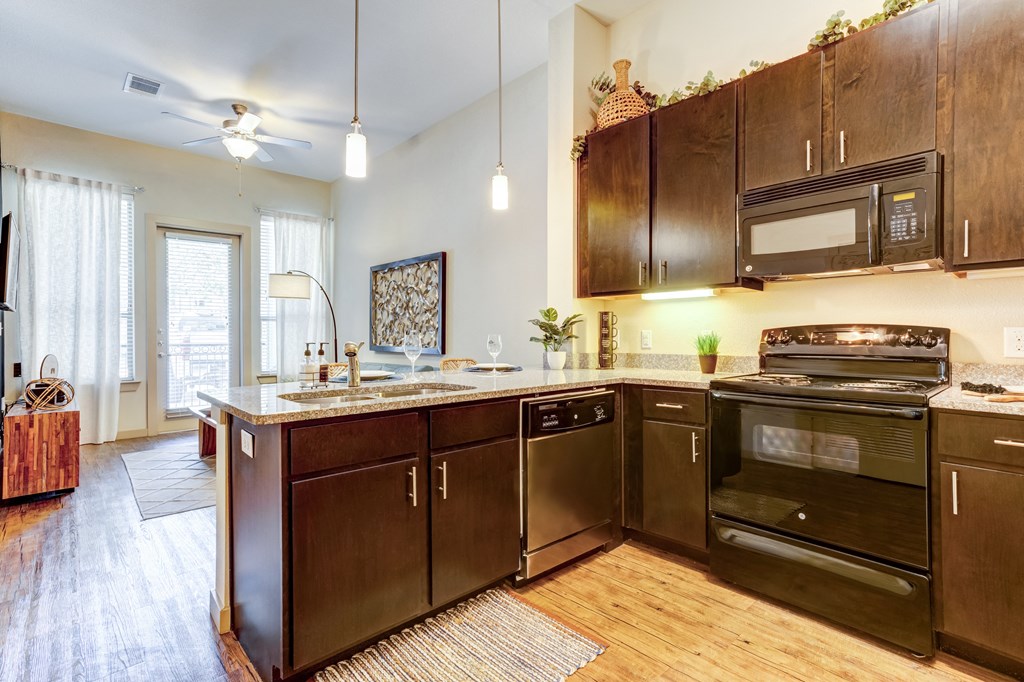 open kitchen with wooden cabinets and stainless steel appliances