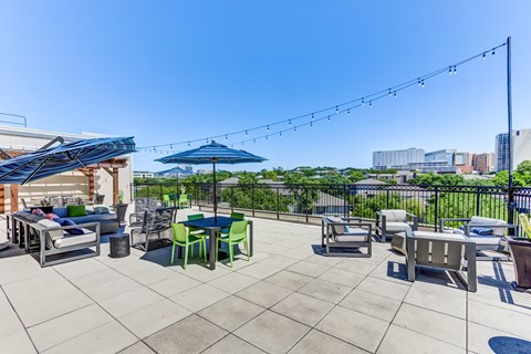 rooftop patio and lounge with tables, couches and umbrellas