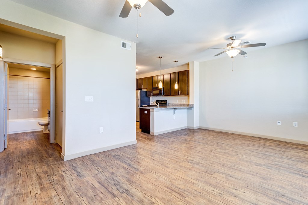 open kitchen and dining area floor plan with wood floors and ceiling fans