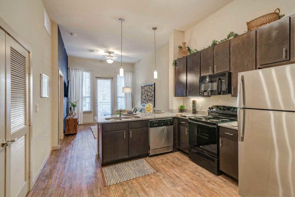 an empty kitchen with a refrigerator and a sink
