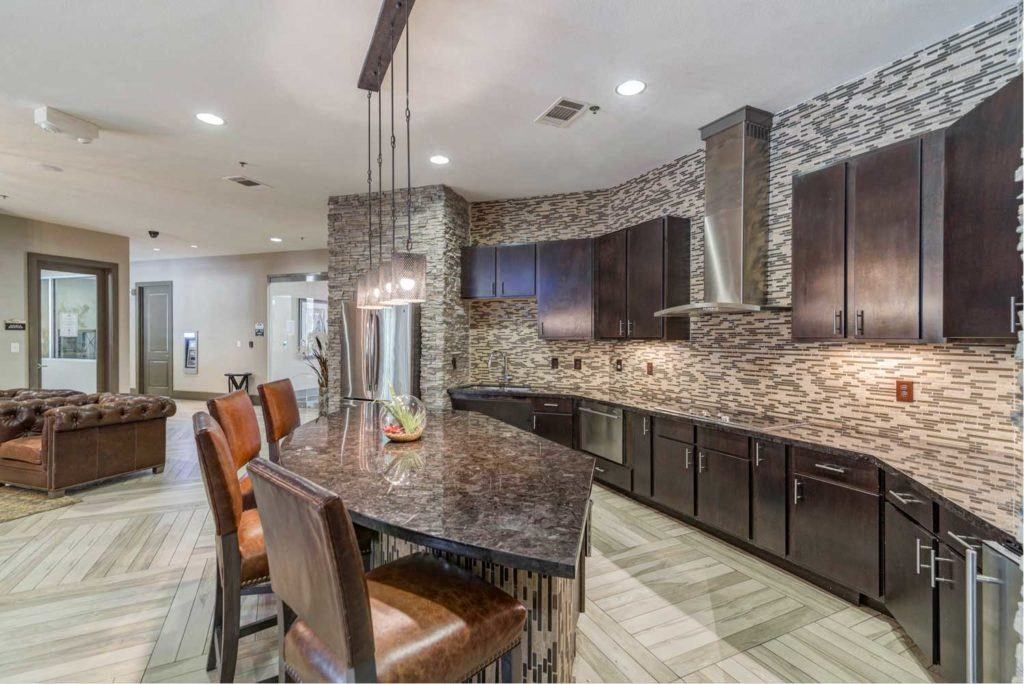 a large kitchen with a bar and a dining table
