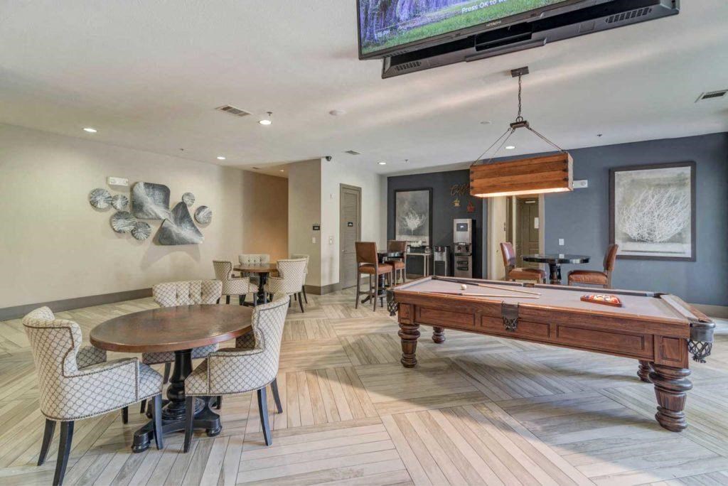 a game room with a pool table and a tv