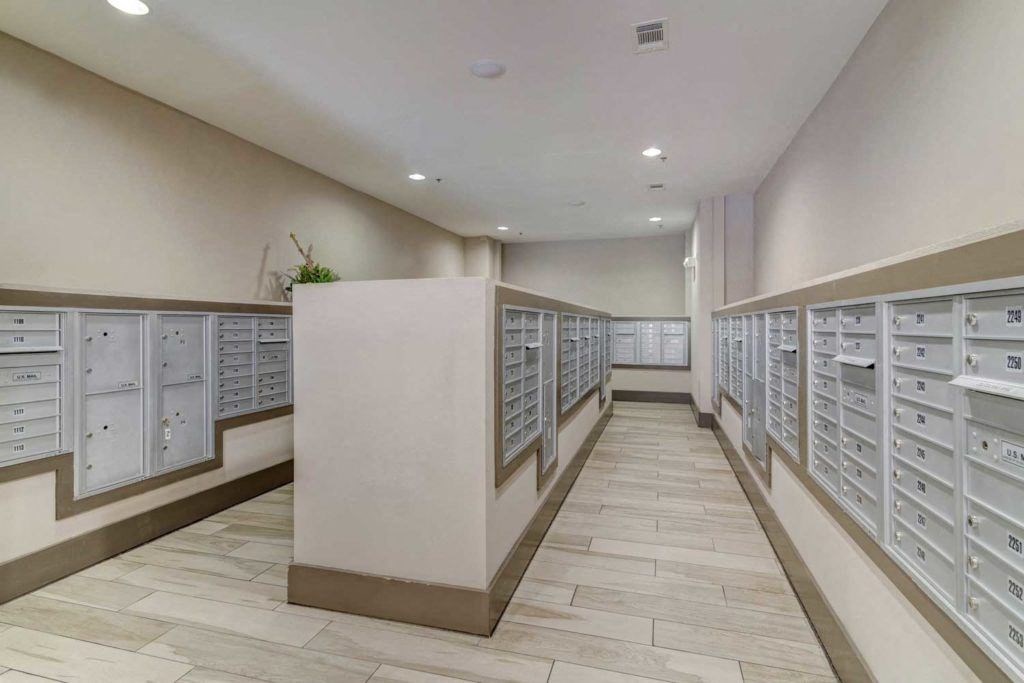 a locker room with lots of mailboxes and cabinets on the wall