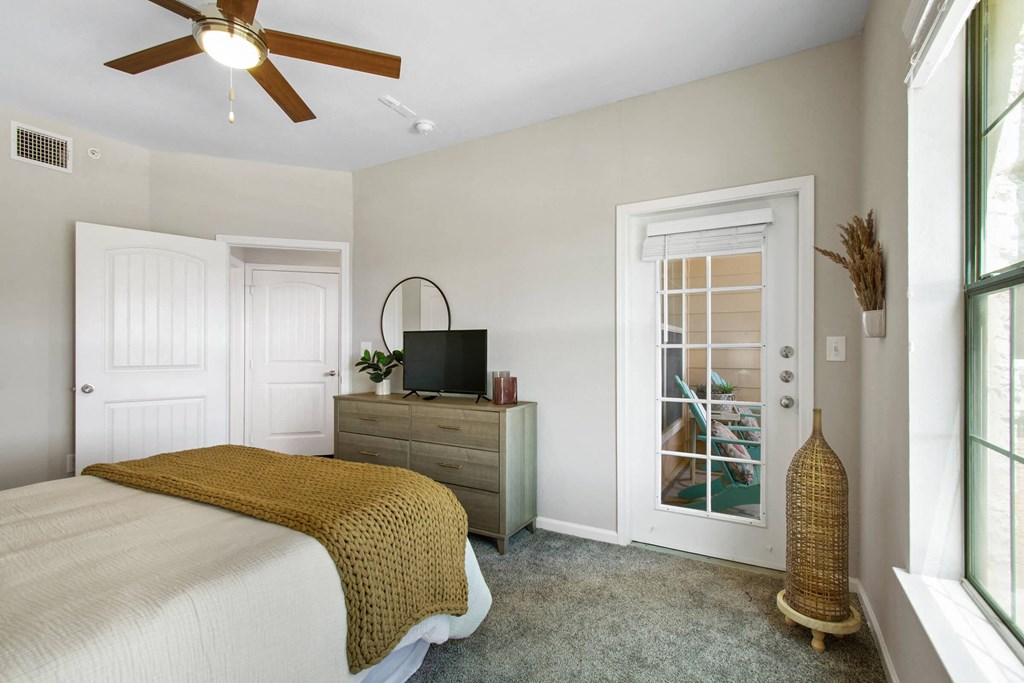 Model Bedroom With Access to Private Patio at Mission Hills Apartments, San Antonio