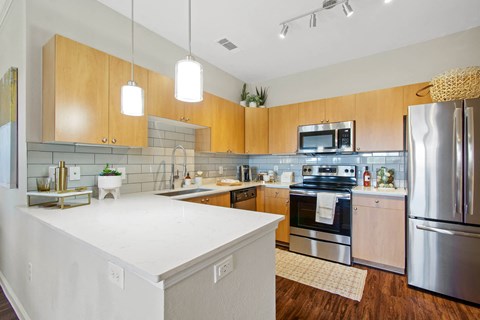 Model Kitchen | Backsplash | Stainless Steel Appliances at Mission Hills Apartments, San Antonio, TX