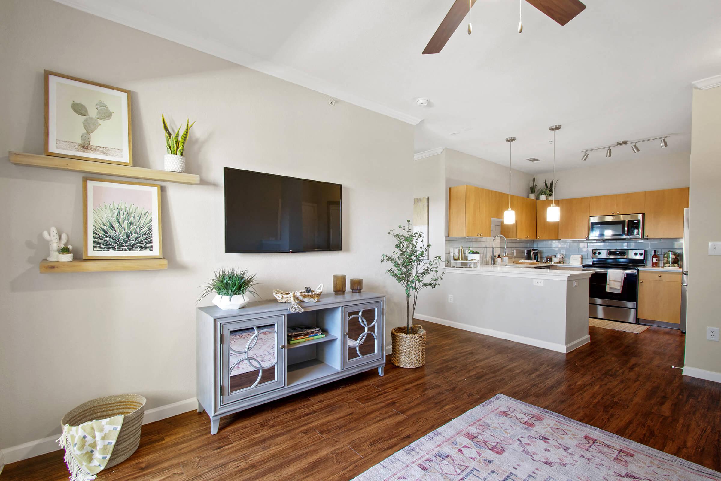 a living room with a kitchen and a tv