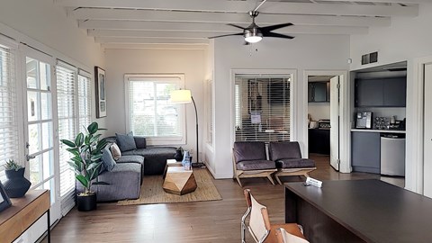 A living room with a grey couch and a brown coffee table.