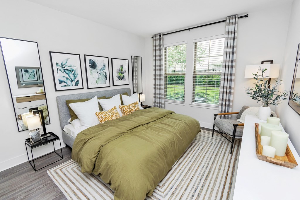 a bedroom with a large bed and a large window