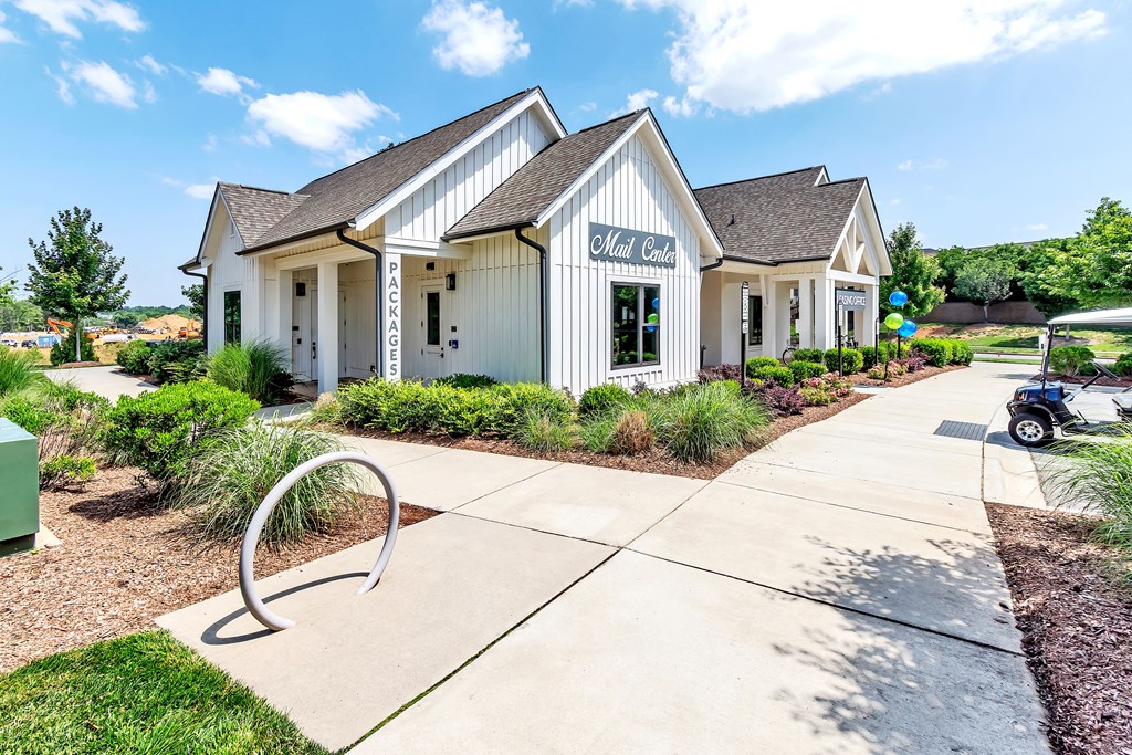 an exterior view of a white building with a sidewalk
