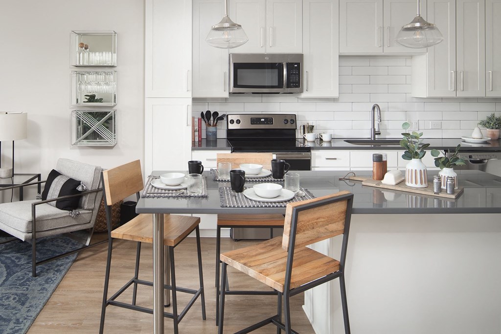 a kitchen and dining area with a table and chairs