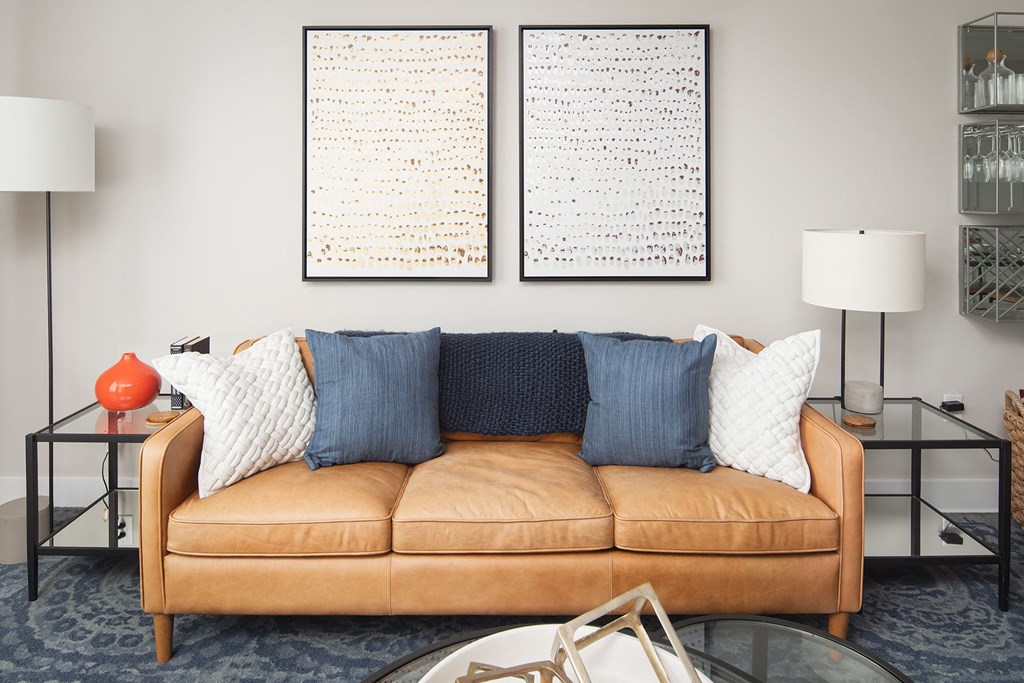 a living room with a couch and two pictures on the wall