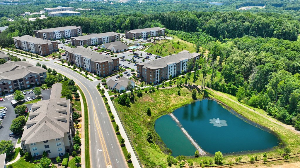 an aerial view of a city with buildings and a lake