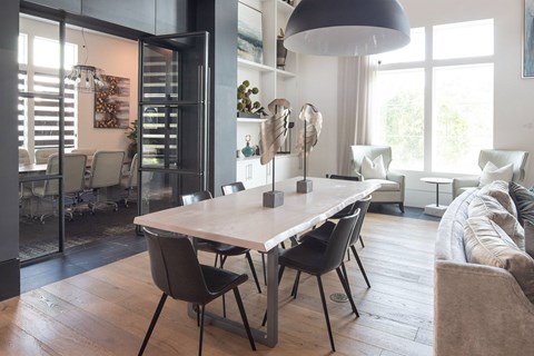 A modern dining room with a large table and chairs.