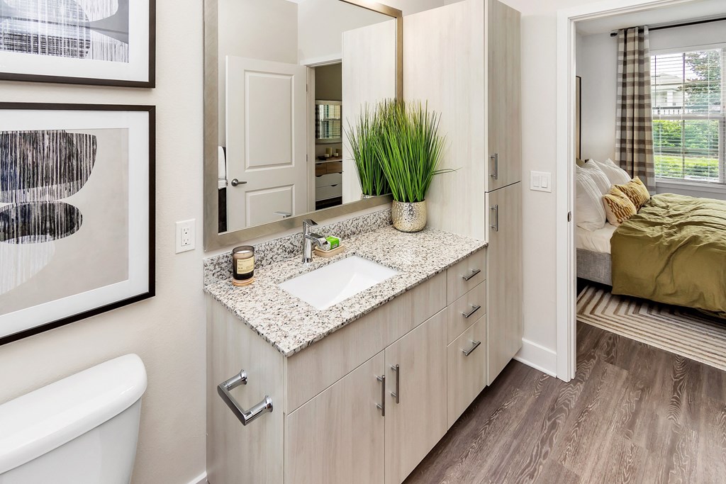 bathroom with vanity and view of bedroom