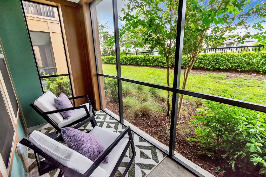 Patio with chairs and a screened in patio
