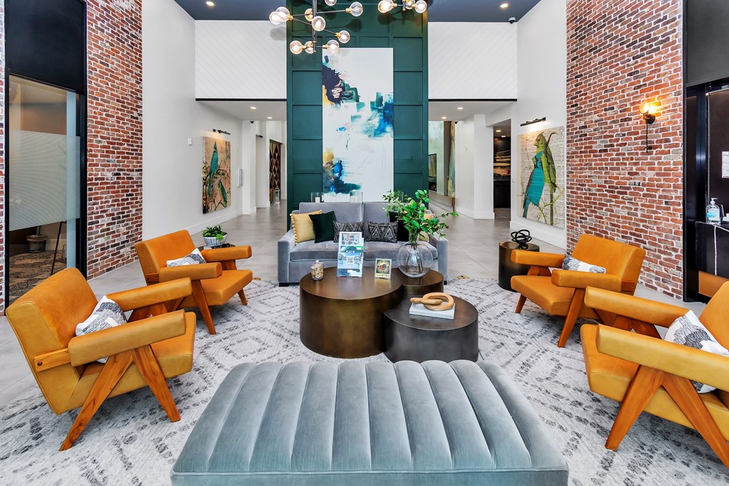 a cluhouse living room filled with furniture and a large window