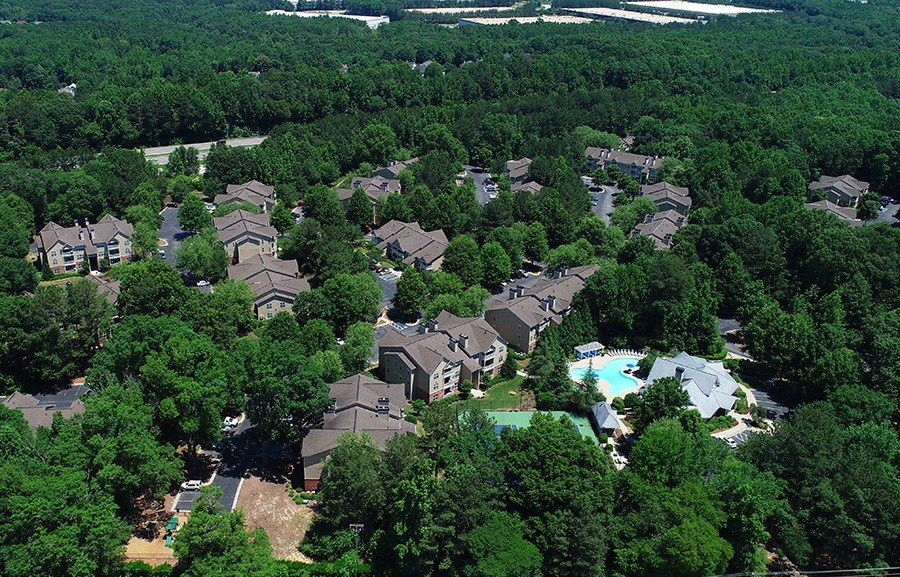 A bird's eye view of a residential area surrounded by trees.