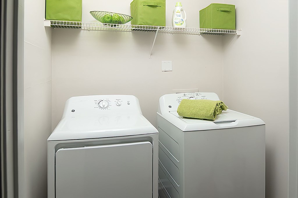 Two front loading washing machines in a laundry room.