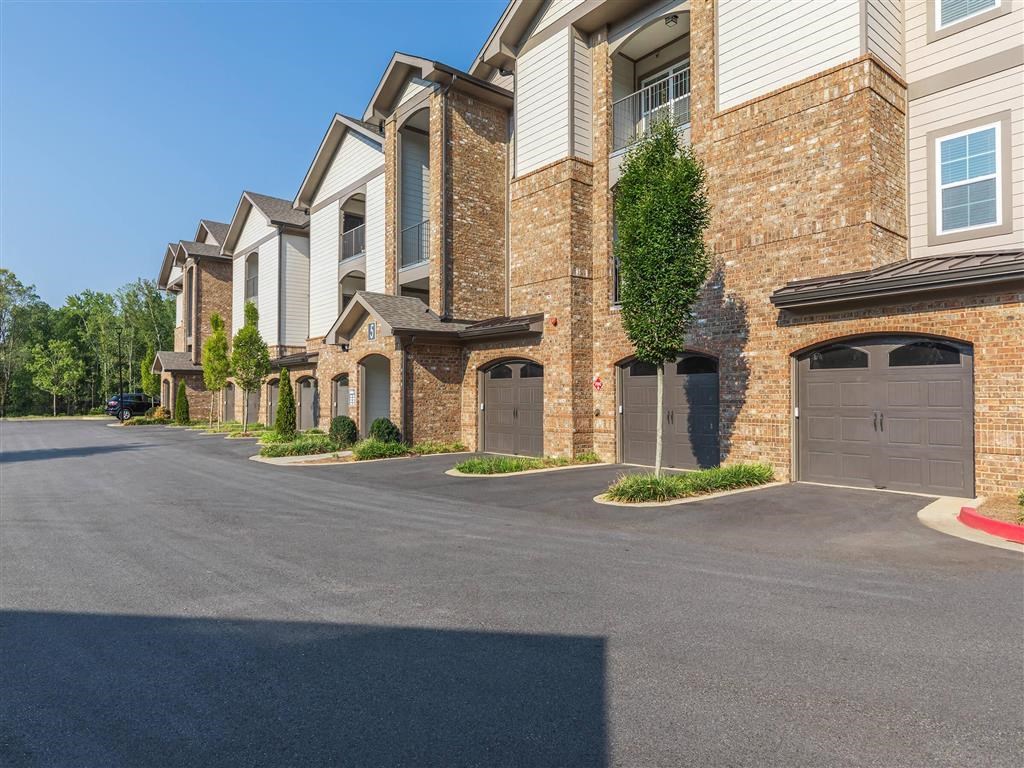 A row of houses with garages and driveways.