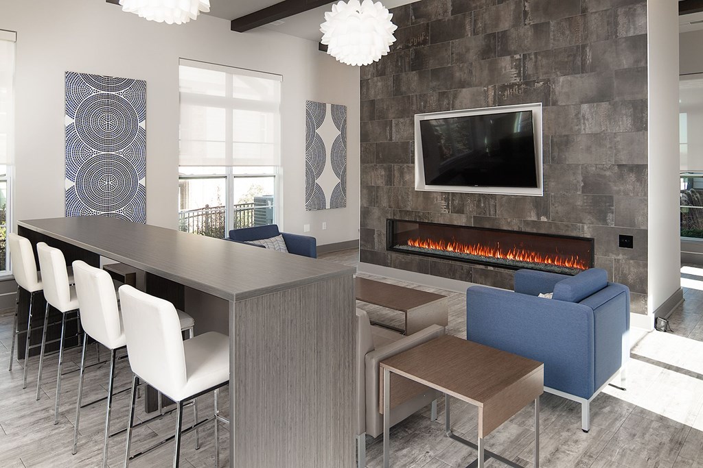 A modern room with a stone wall and a fireplace.