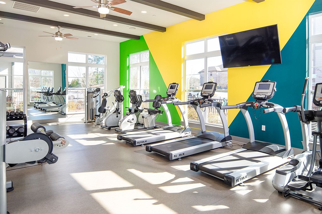 A gym with treadmills and exercise bikes.