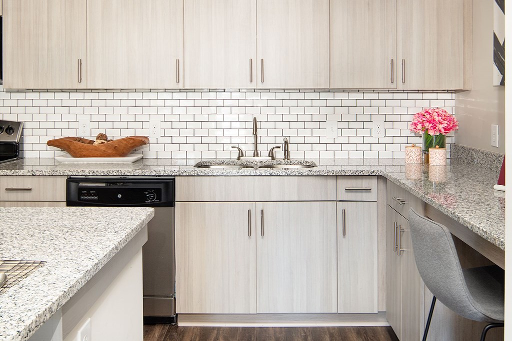 A kitchen with white cabinets