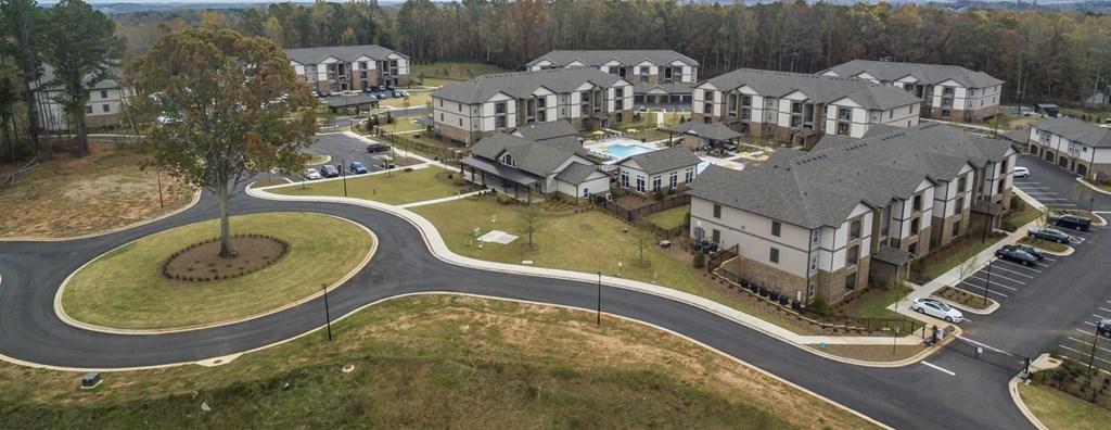 A large roundabout is in the center of a housing development.