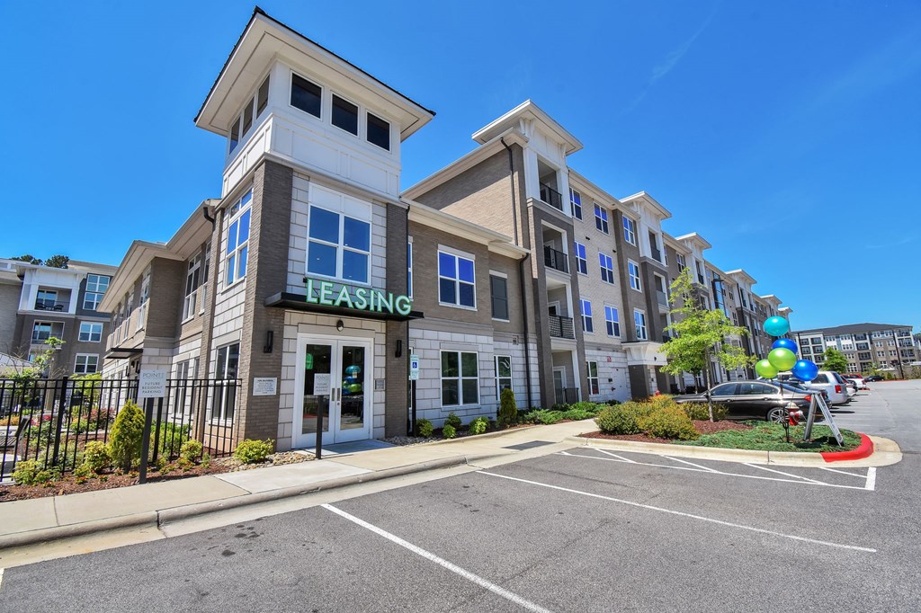 A multi-story building with a leasing sign on the front.