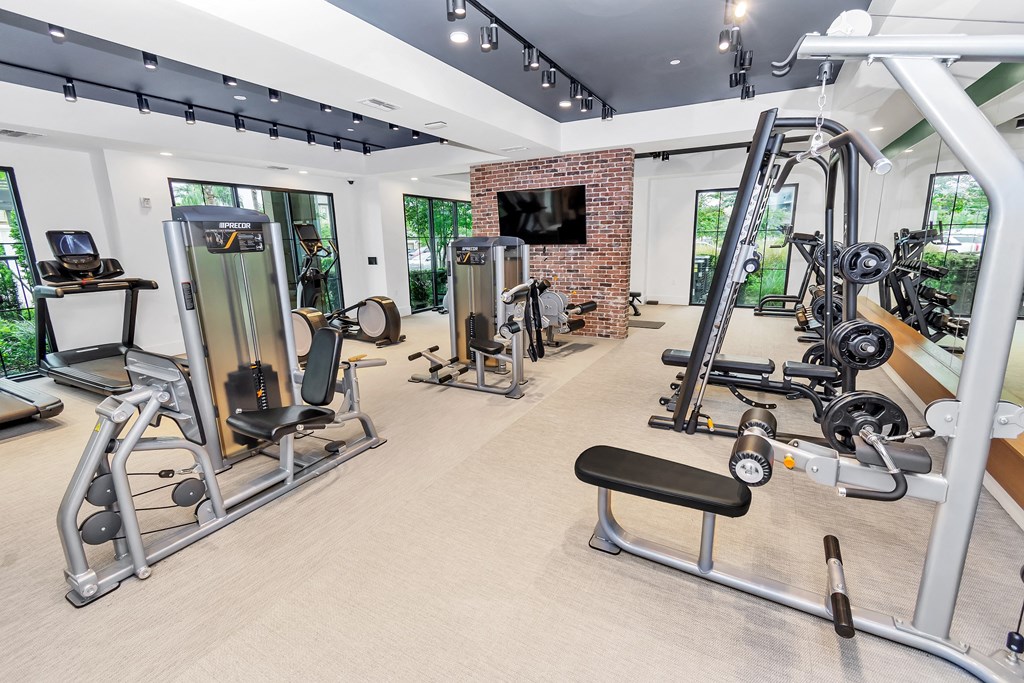 a room filled with lots of different types of exercise equipment