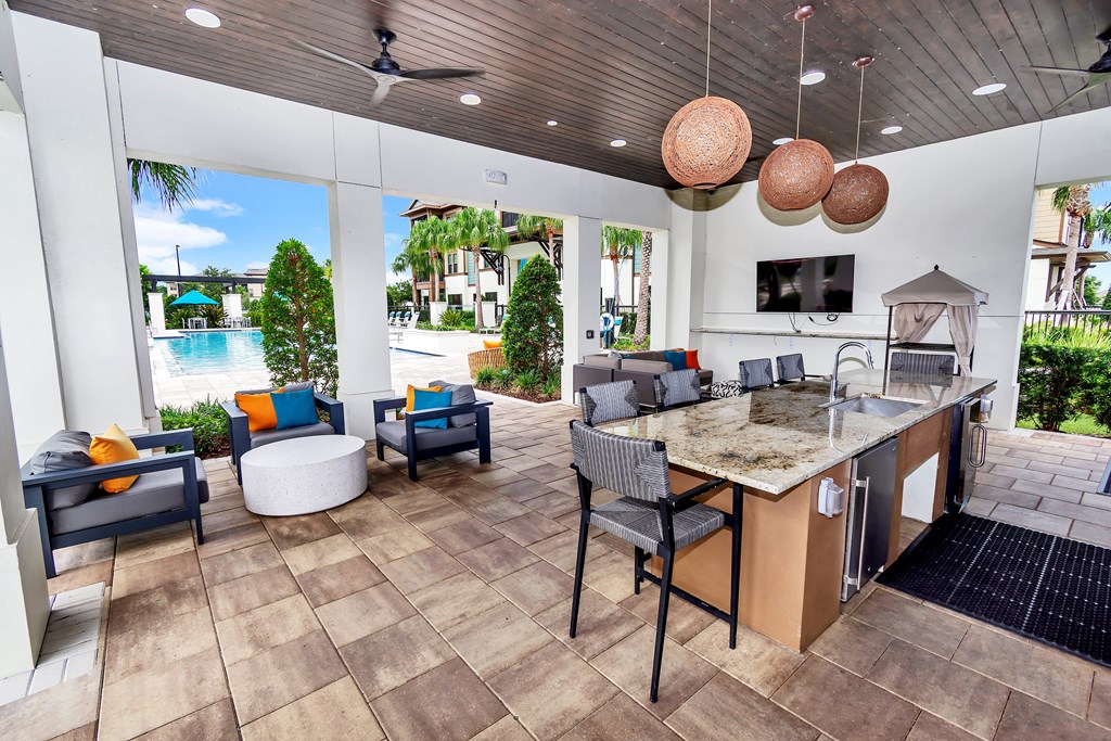 take a seat at the kitchen island and enjoy the views of the pool and beach