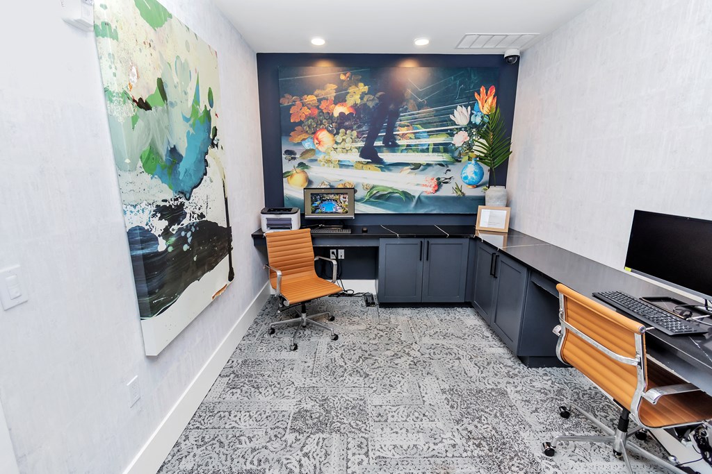 an office with a large painting on the wall