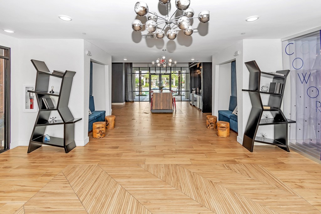 a room with a wood floor and a chandelier