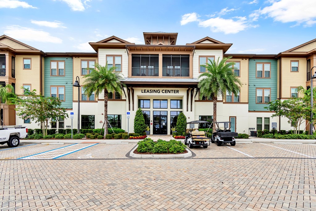 a large building with palm trees in front of it