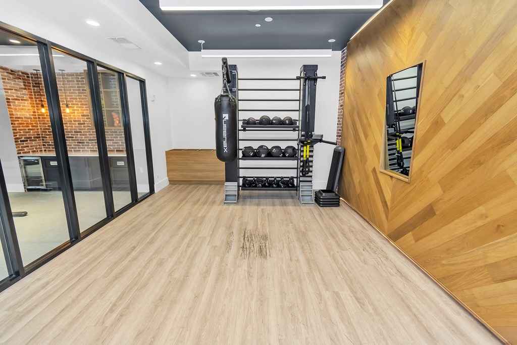 gym with hardwood floors and white walls