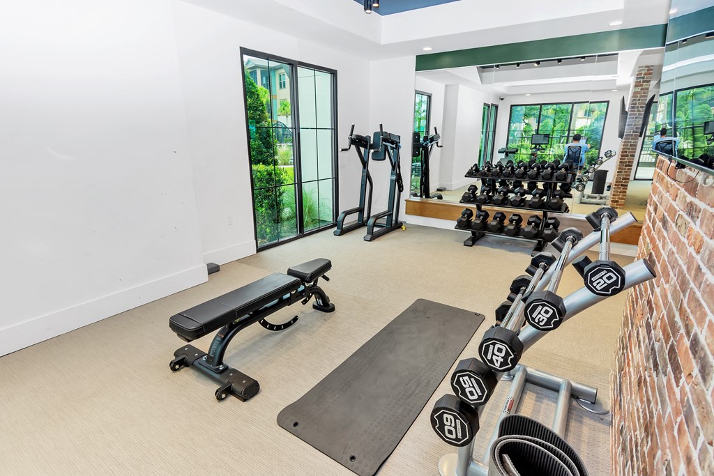 a workout room with weights and other exercise equipment