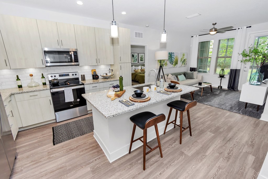 a kitchen with a large island with a granite countertop