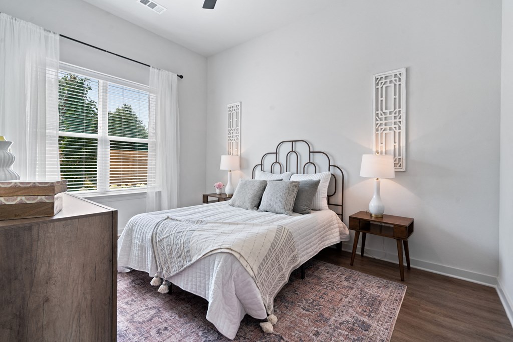 a bedroom with a bed and a large window