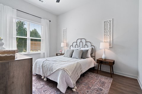 a bedroom with a bed and a large window